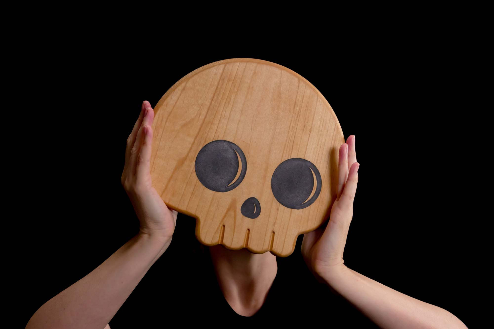 Stylish cutting board with a cute skull design, perfect for any gathering.