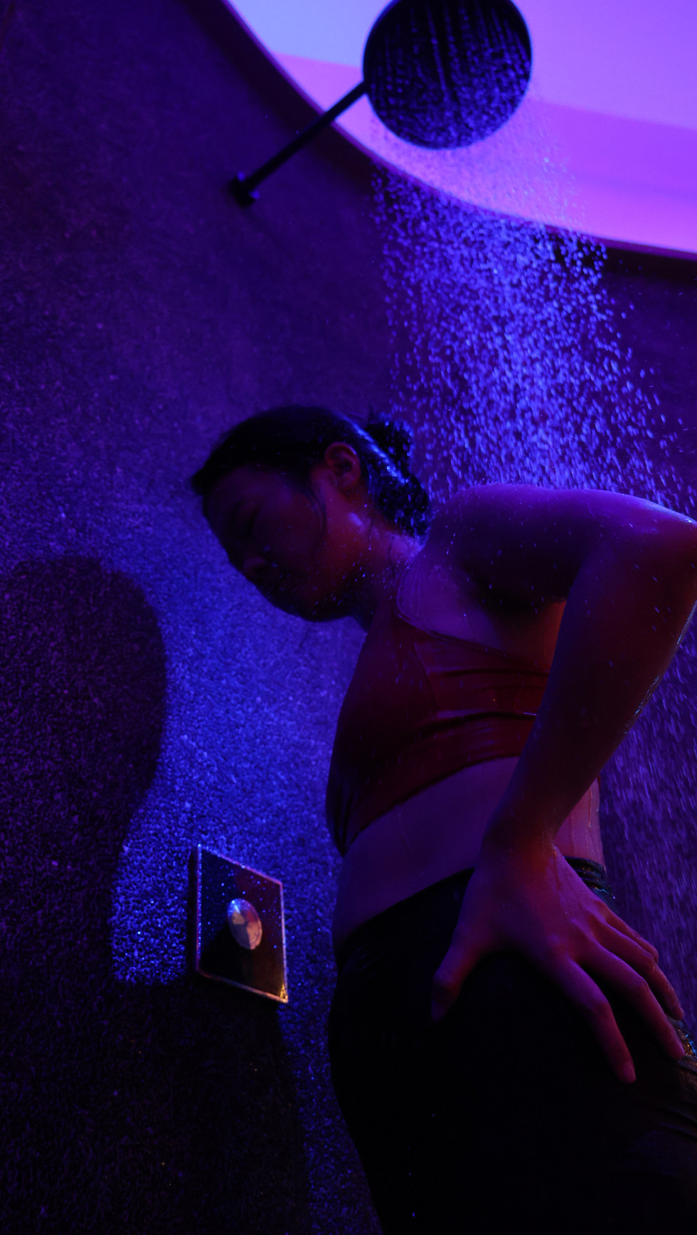 Woman taking slow, controlled breaths during her first SejukSix 6°C cold shower session at Revibe