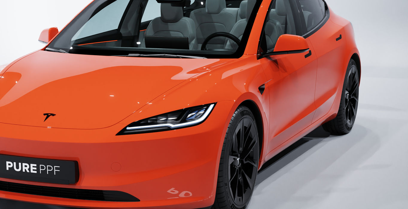 Front angle view of a Tesla Model 3 wrapped in PurePPF Gloss Scarlet, displaying the passionate and bold look of the rich red finish with hints of orange.