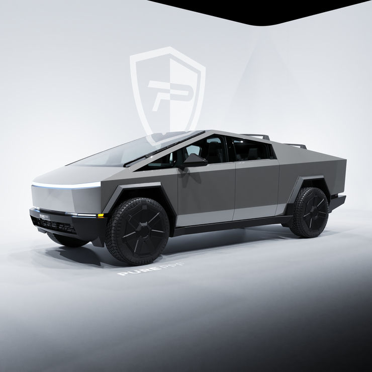 Side view of a Tesla Cybertruck wrapped in PurePPF Cement Gray, highlighting the sleek and refined appearance with the solid warm tone gloss gray finish.