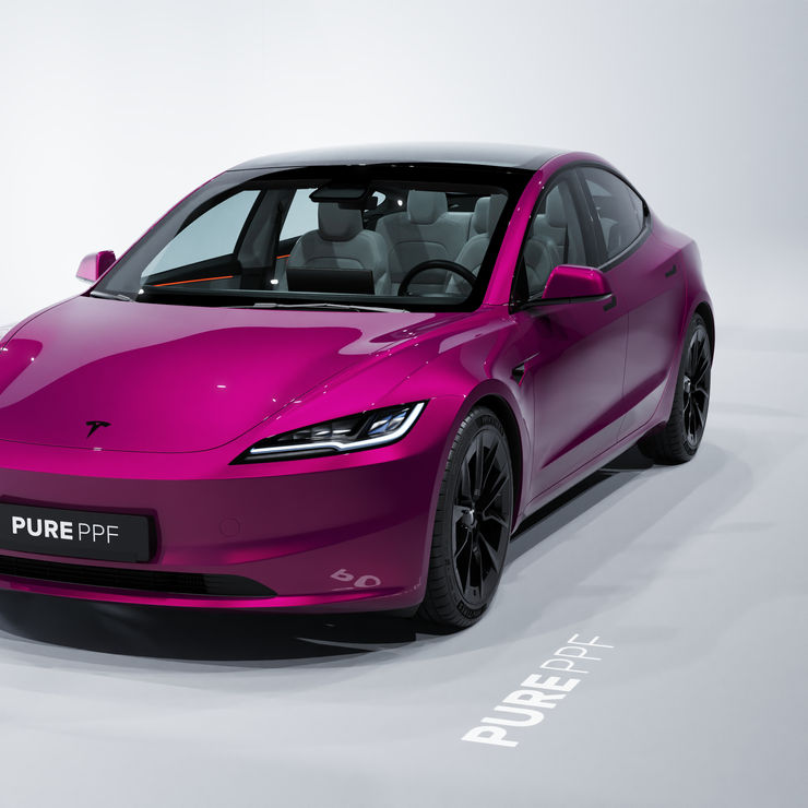 Front angle view of a Tesla Model 3 wrapped in PurePPF Metallic Magenta, displaying the bold and glamorous look of the vibrant magenta finish with a metallic sheen.