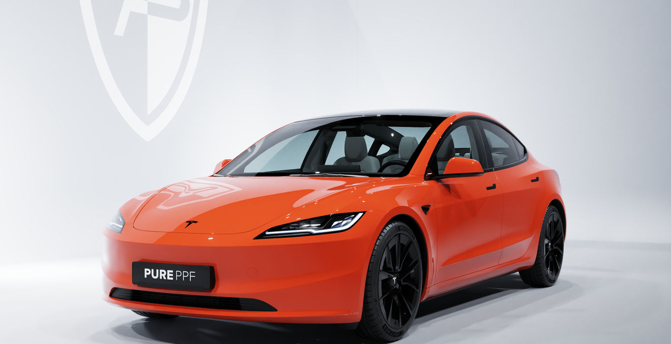 Front view of a Tesla Model 3 wrapped in PurePPF Gloss Scarlet, showcasing a rich and intense shade of red with hints of orange.