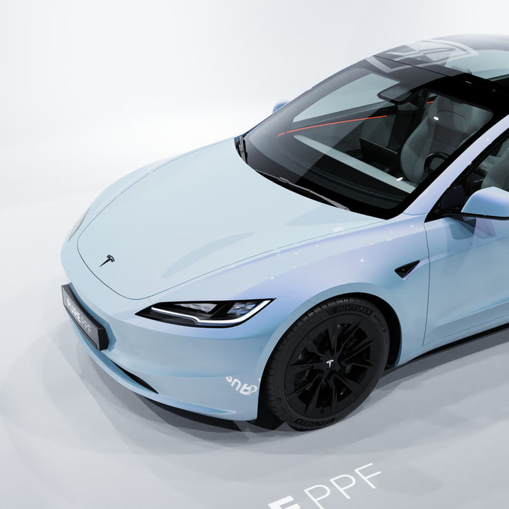 Close-up of a Tesla Model 3's front, wrapped in PurePPF Ice Blue, highlighting the detailed cloud blue finish with subtle gold metallic flakes for a refreshing and modern appearance.