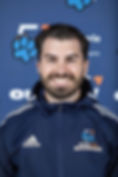 Smiling adult man, wearing an "Ontario Tech Ridgebacks" jacket