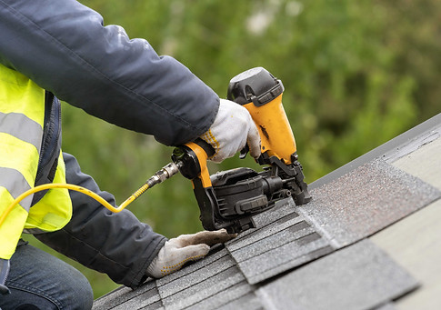 roofer installing shingles