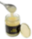 Spoon scooping Irish Seamoss gel from an open jar with black label. The jar is on a white background with the lid beside it.