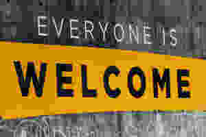 Everyone is Welcome painted on concrete wall.