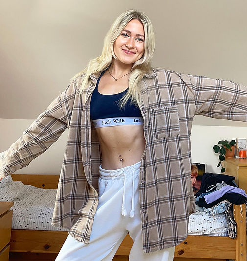 A photograph of me posing and showing my abs.