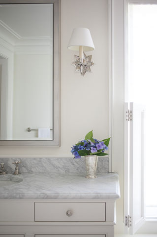 elegant bathroom details mirror and light sconces.