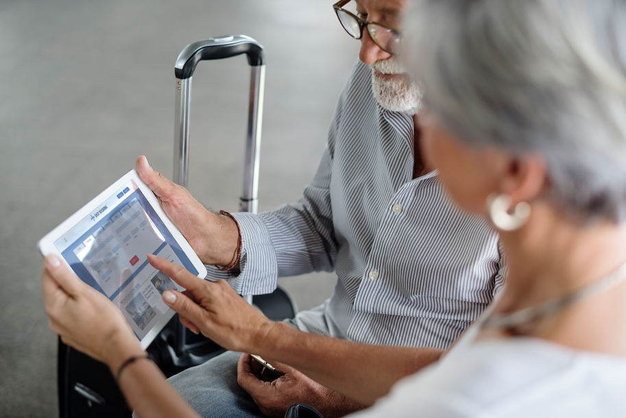 senior-couple-traveling-airport-scene (1).jpg