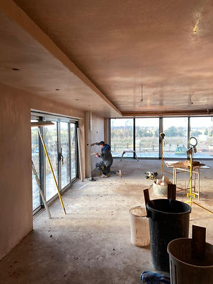 A large open room being plastered