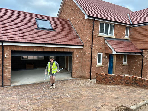 A young plasterer outside a new build house