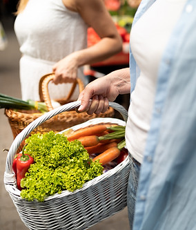 Women carrying fresh produce in market baskets