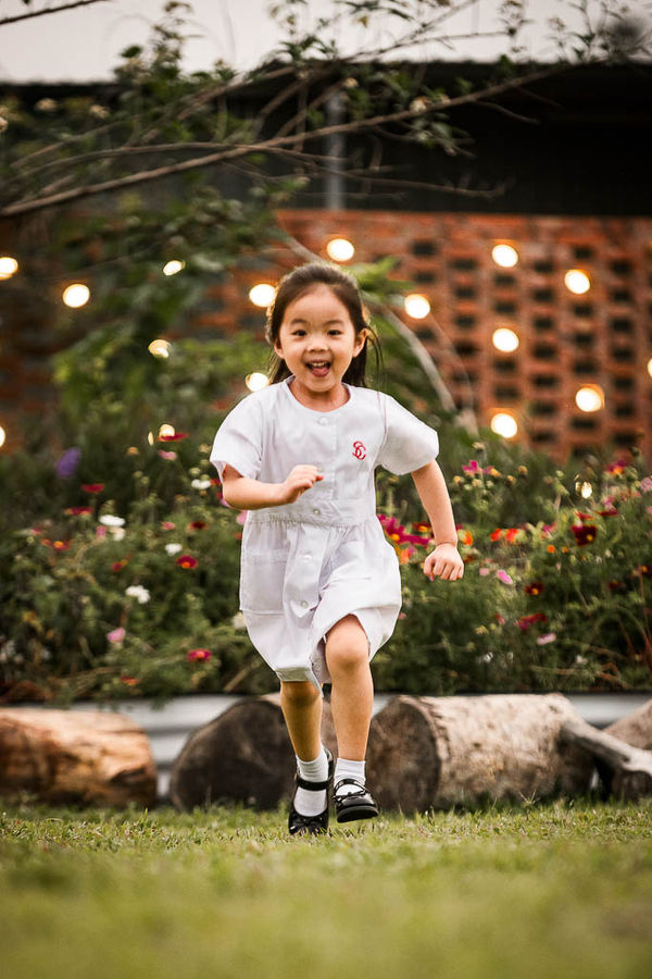 Young students participating in a backyard photography class playing with water pipes and splashing.