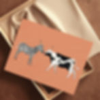 A cow and zebra in profile look at each other with surprised expressions. They are drawn on an orange background.