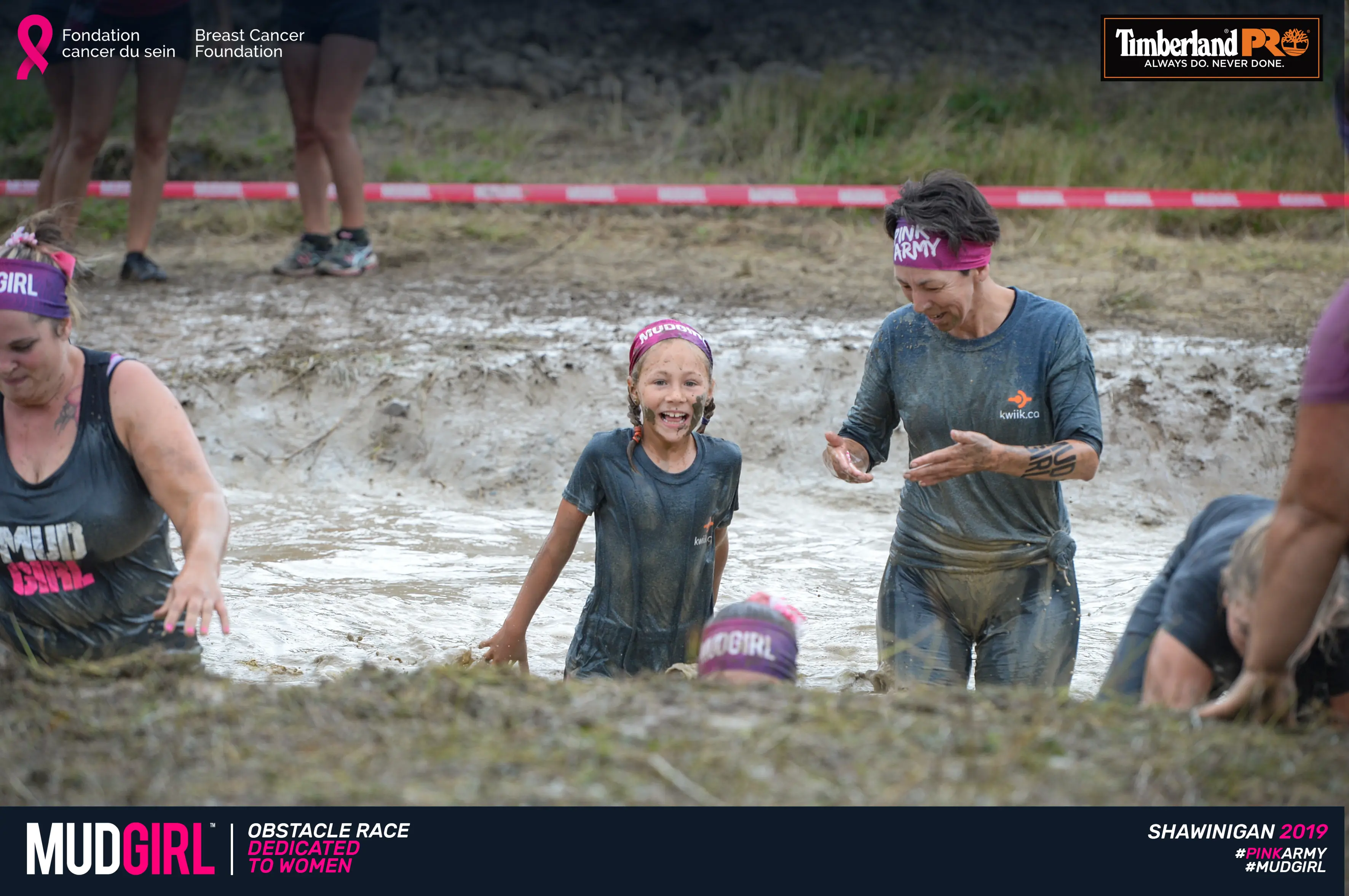 Kwiik team members wading through a mud pit at the MUDGIRL obstacle race