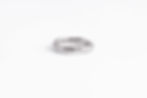 Sterling silver ring with irregular engraved line, flat lay view – minimalist and symbolic design.