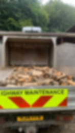 a load of firewood on the back of a truck ready for delivery