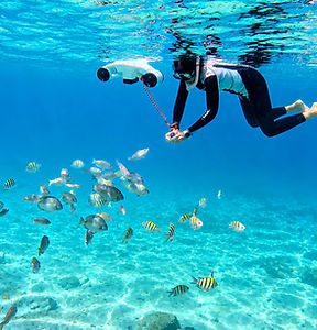 Kristy feeding fish on a underwater scooter tour.