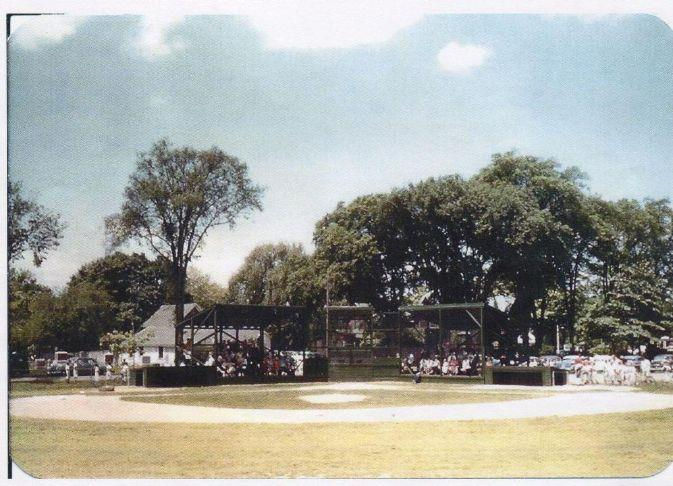 little league baseball field with trees in background