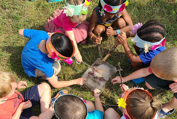 Children in nature sitting in a circle