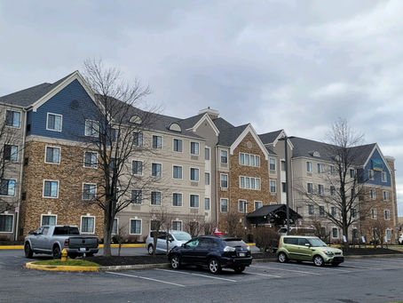 A large building with an open parking lot