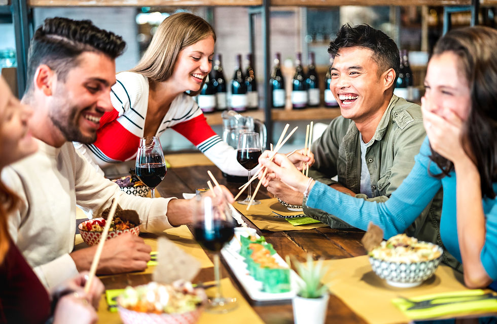 Friends enjoying food and drinks at izakaya.