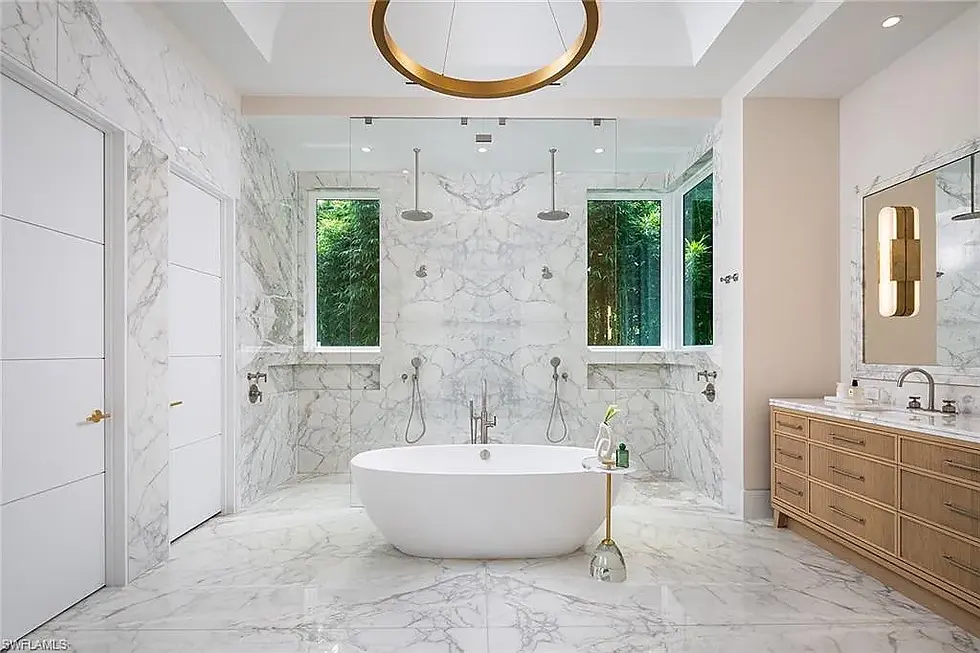 Spacious bathroom with standalone bathtub and large windows