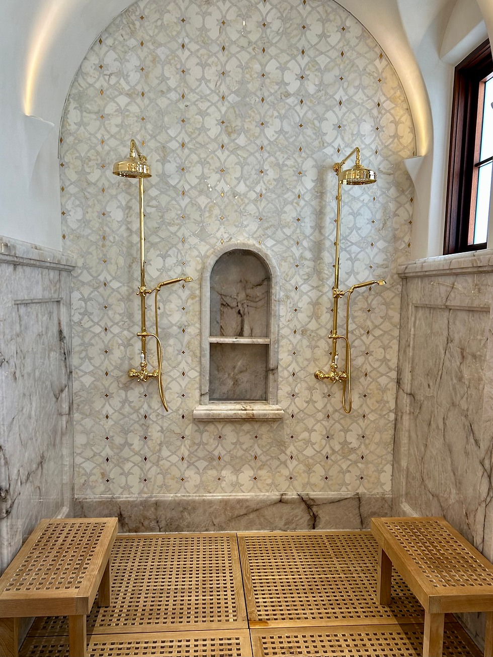 Large walk in shower with gold fixtures