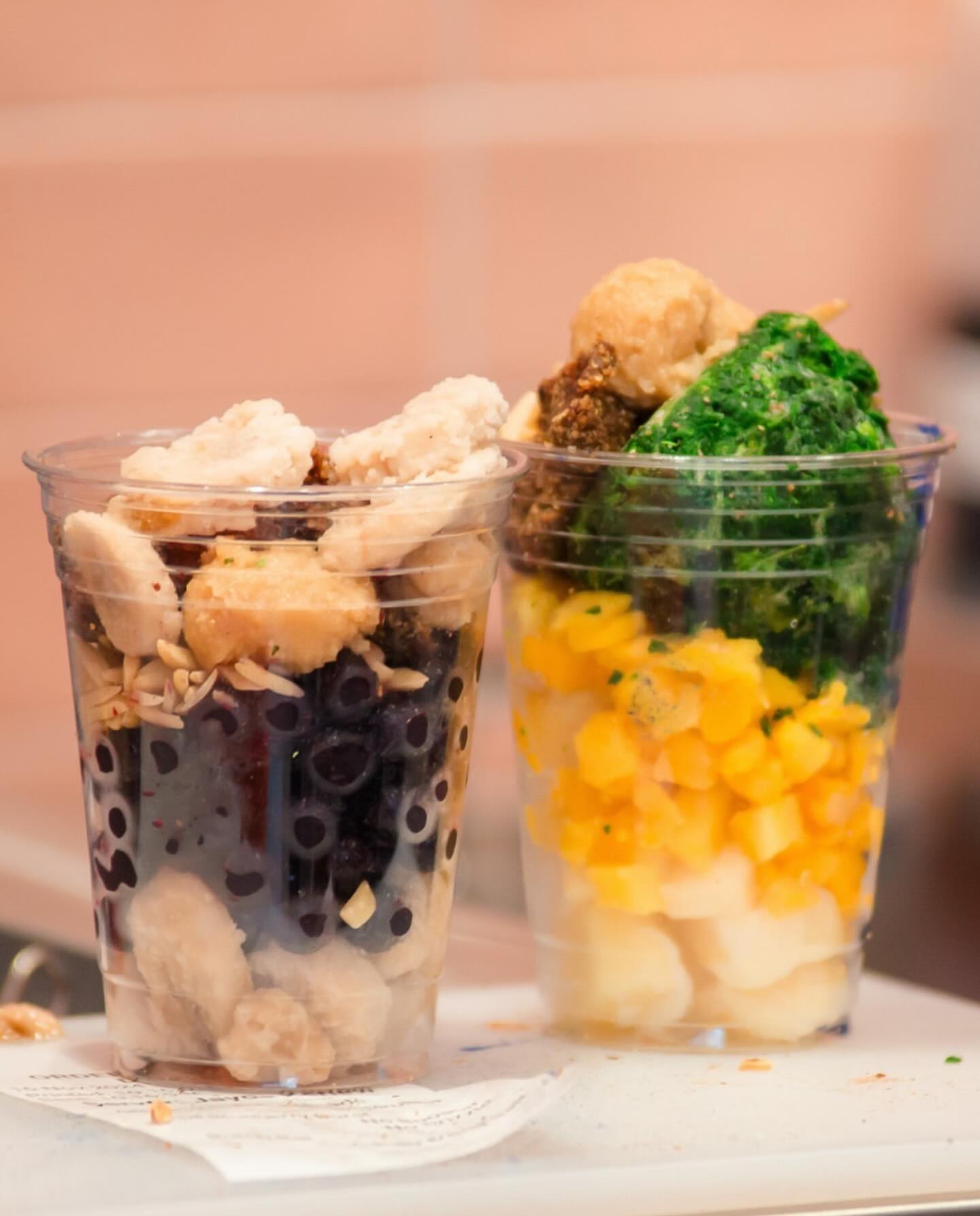 Clear jar parfait with yogurt, mango, berries, and granola layers.