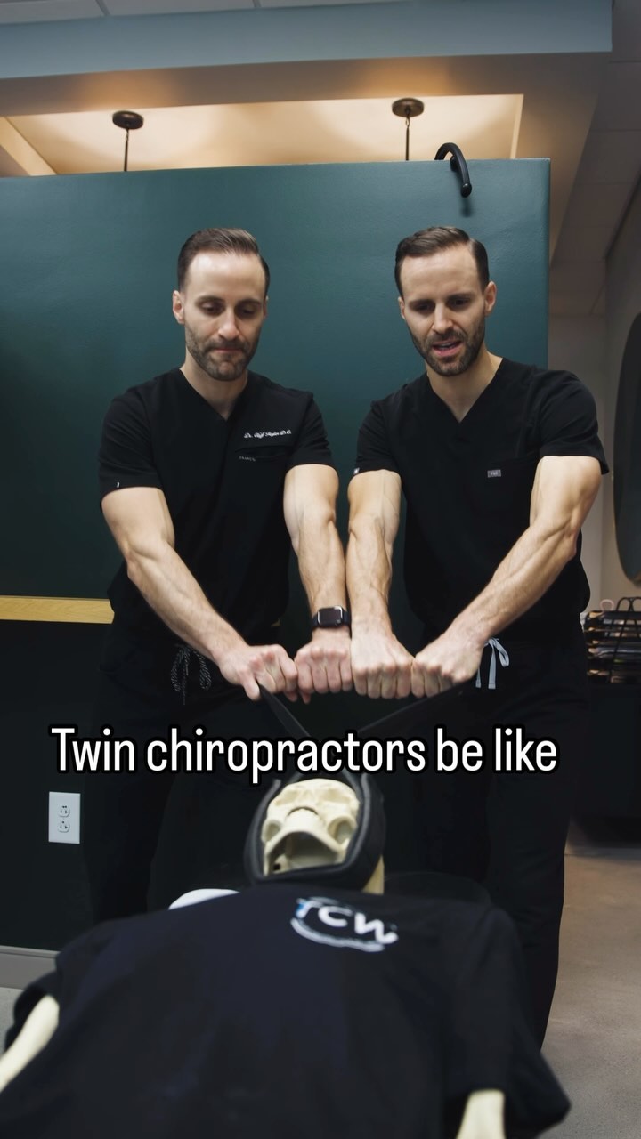 Poster of two doctors with wellness slogan inside clinic hallway.