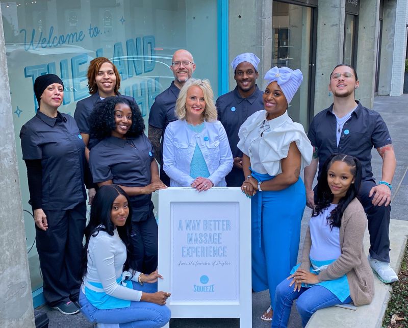 Squeeze Midtown Atlanta Colony Square staff group photo in front of studio entrance.