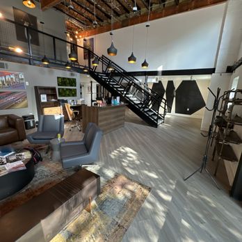 Lobby and reception area of Taylor Chiropractic Buckhead with staircase and seating.