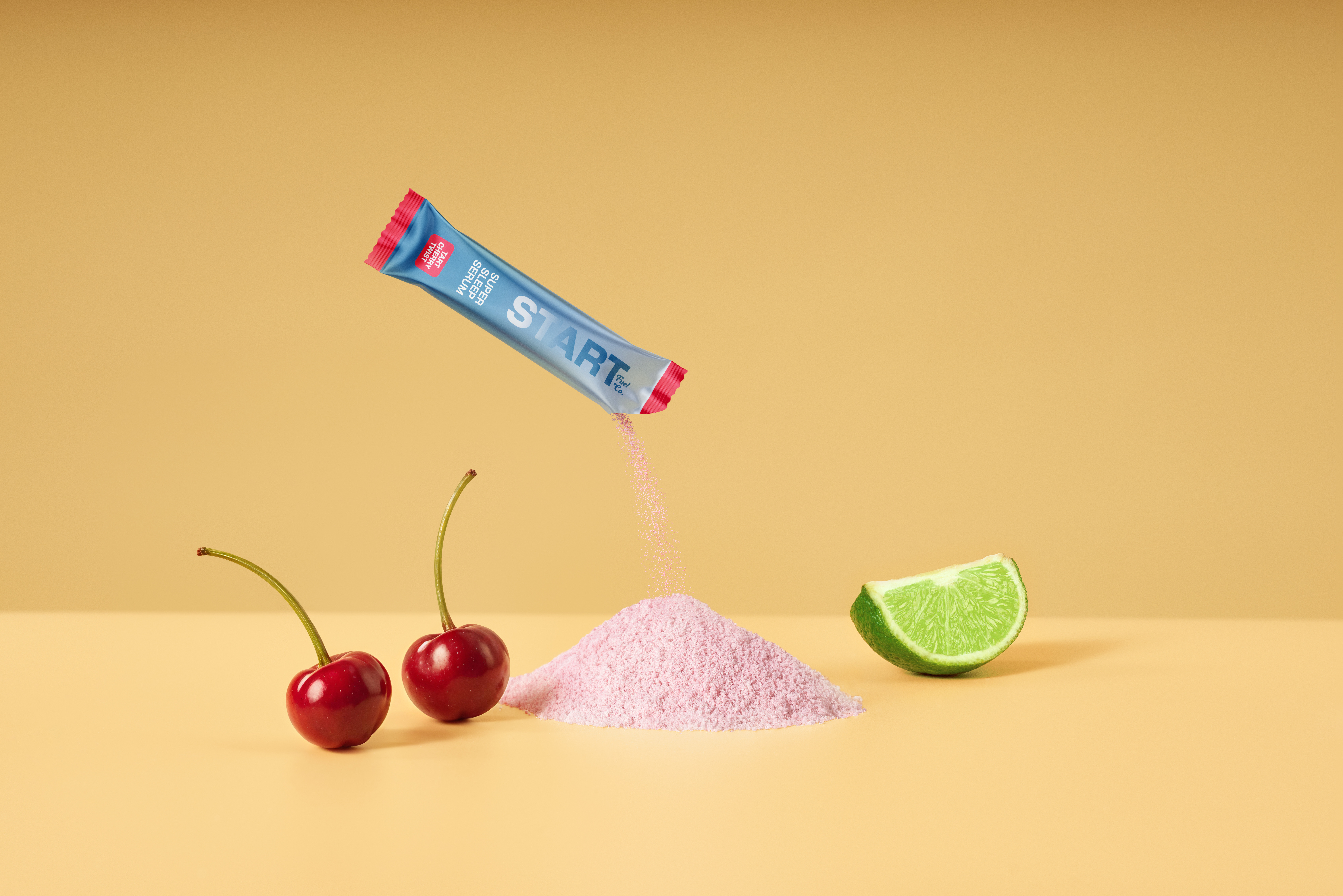 Stick pack floating over pink powder with cherries and a lime wedge on a beige backdrop.