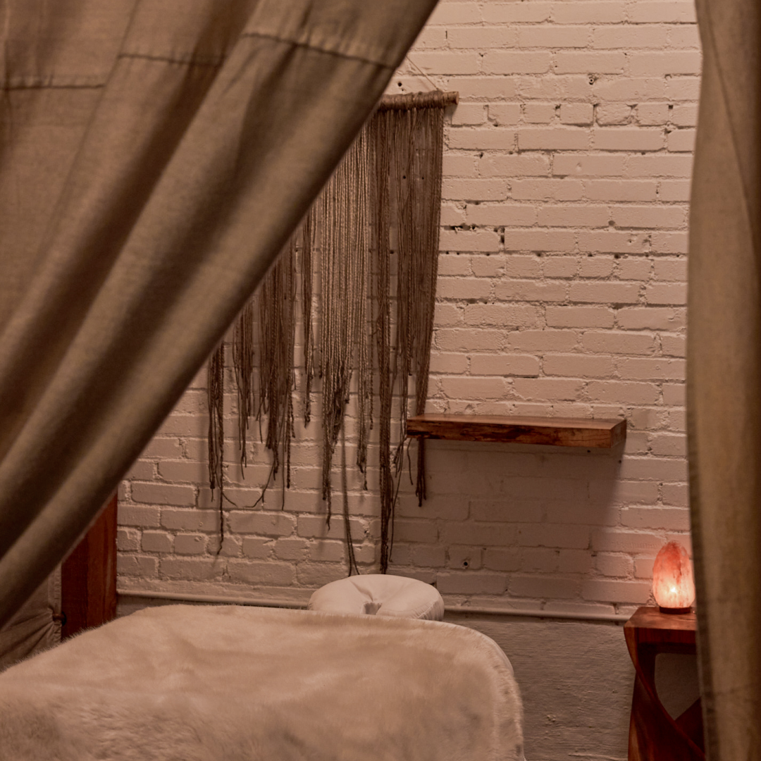 Intimate Journey Room with curtained walls and candle at The NOW Massage Mount Pleasant.