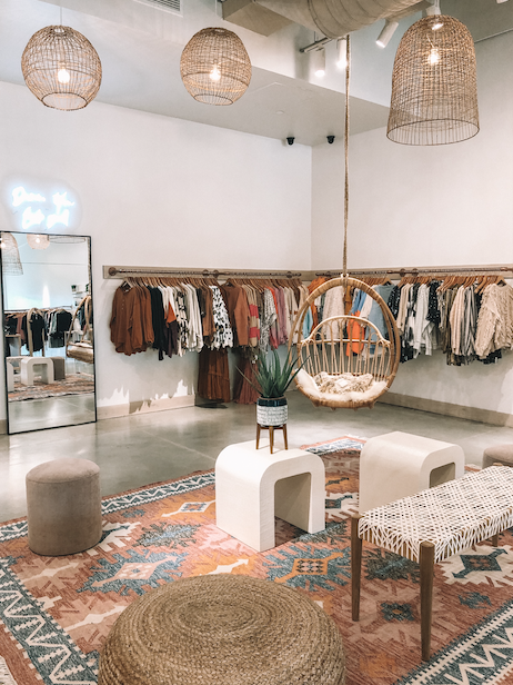 Nina + Leigh Alpharetta boutique interior with clothing racks and blush decor