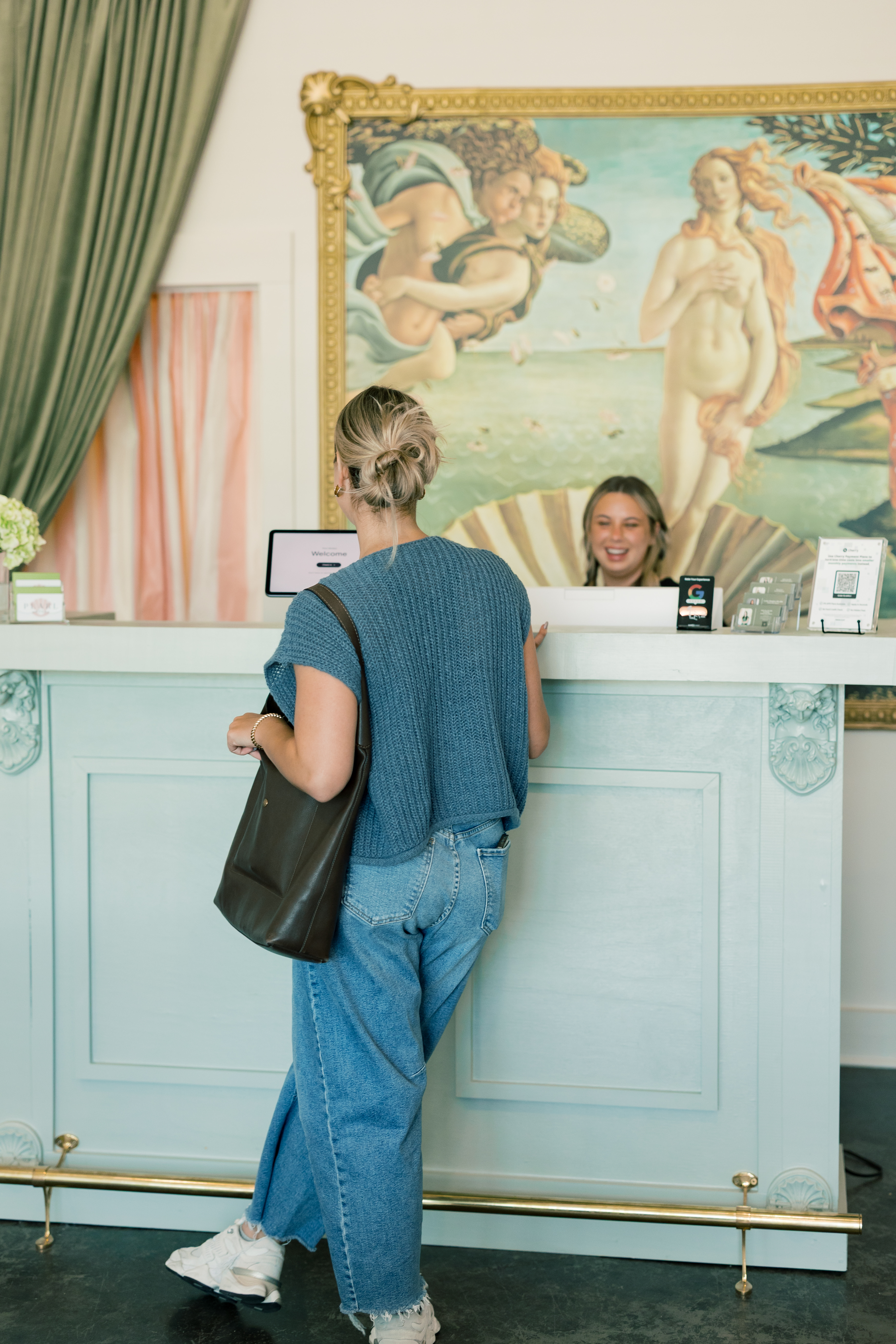 Client checking in at the front desk of Pearl Medspa Charleston.