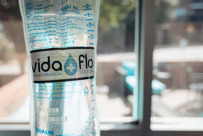 Close-up of Vida-Flo IV drip bag hanging on pole inside Vida-Flo Decatur Atlanta clinic.