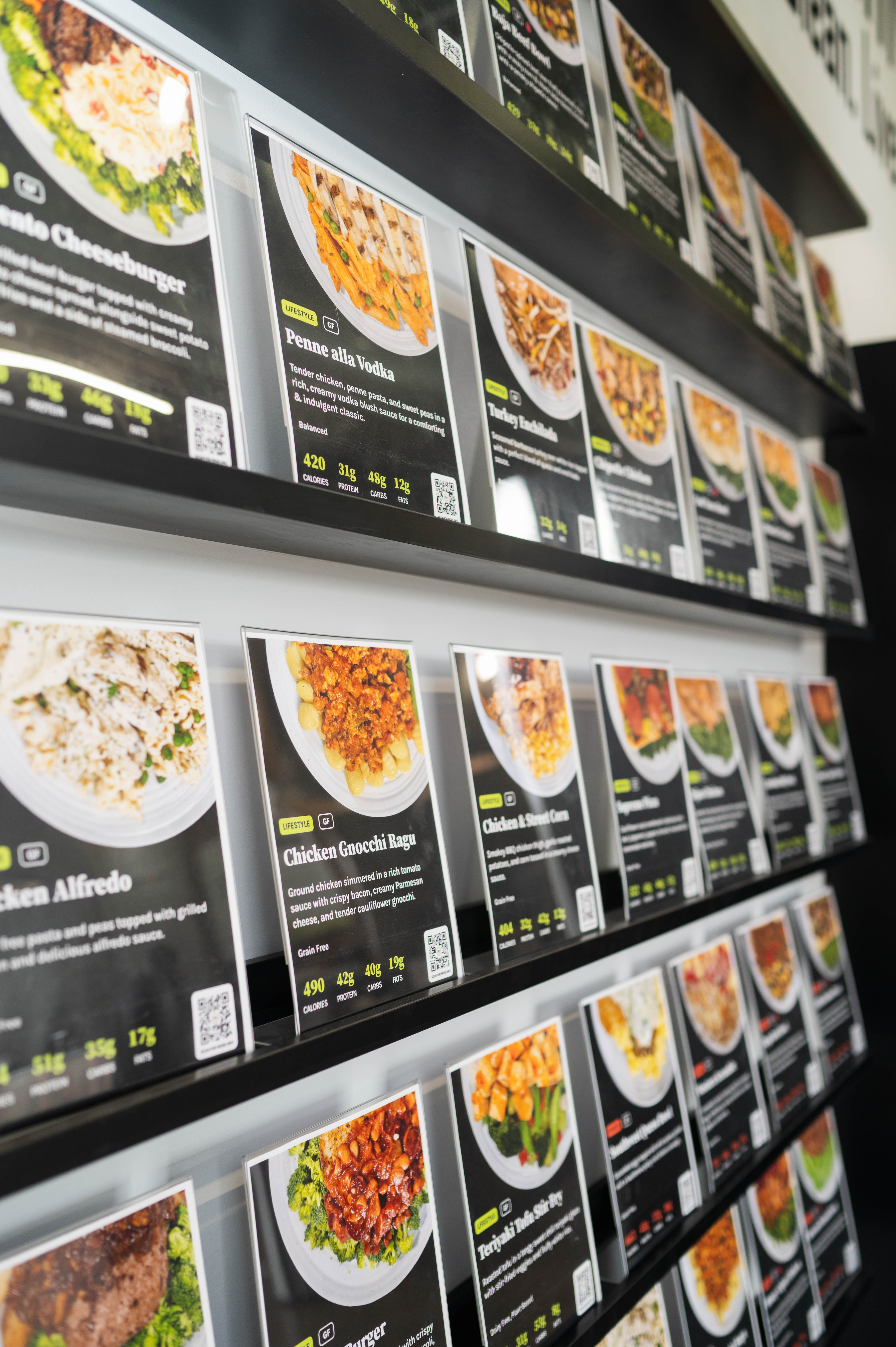 Wall of menu photos and descriptions inside Project LeanNation South End Charlotte.