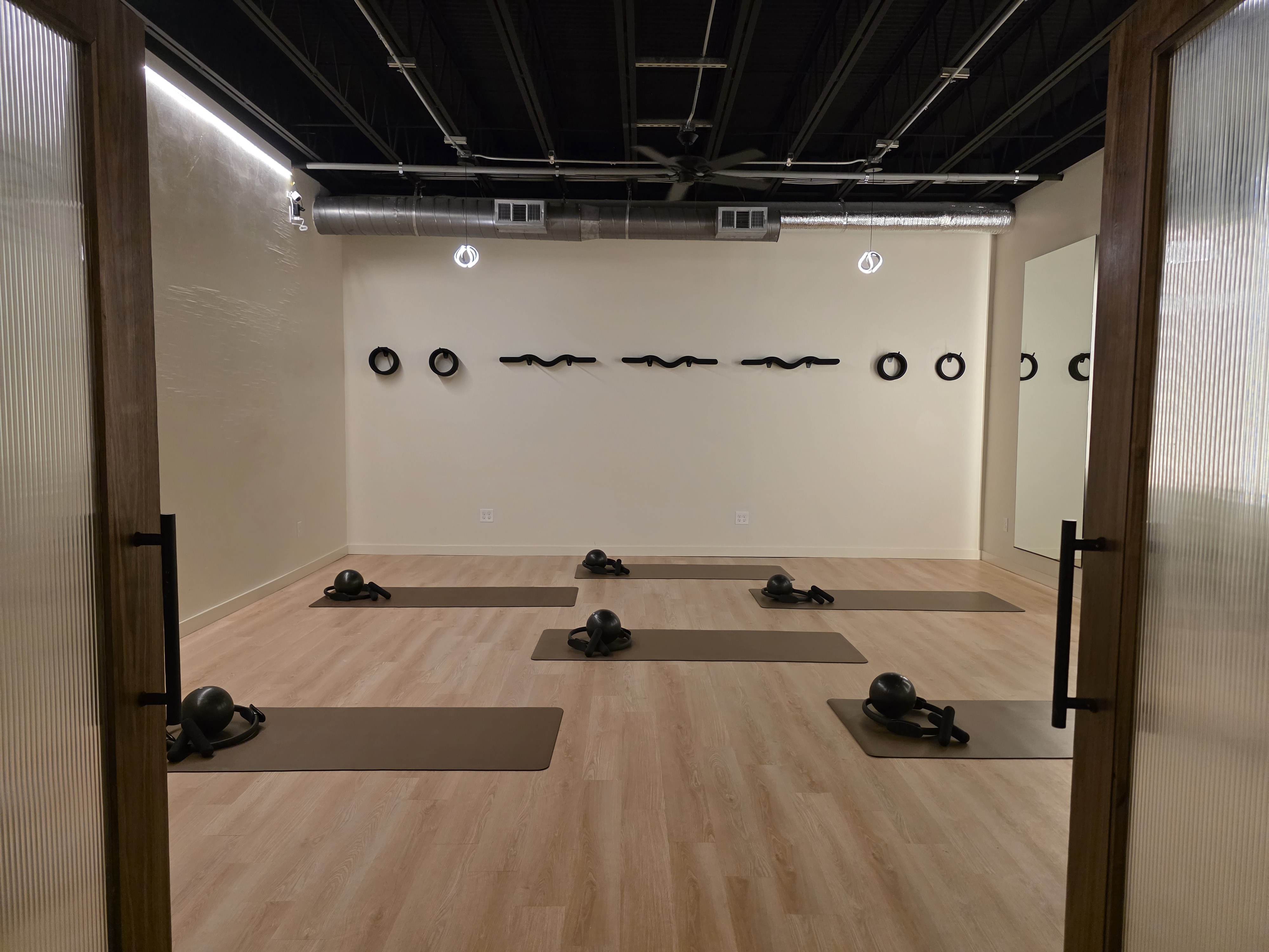 Reformology Pilates Avondale Estates studio with reformers and wood floors