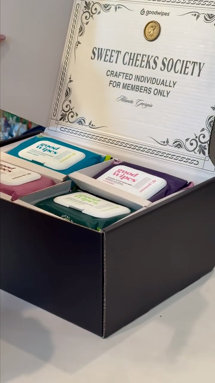 Assorted Goodwipes wipes arranged in a black box beside an award plaque