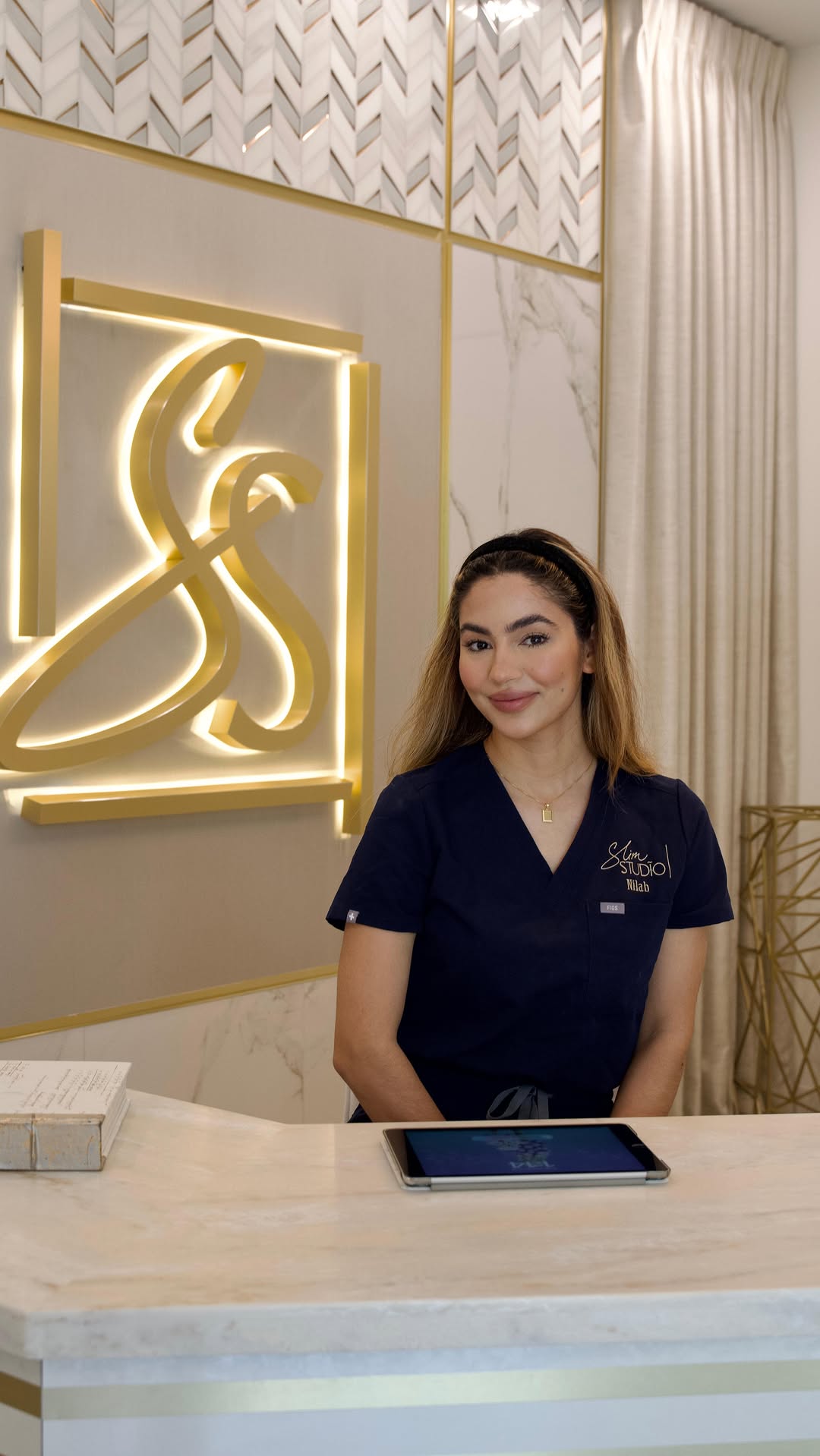 Slim Studio Buckhead reception desk with gold logo