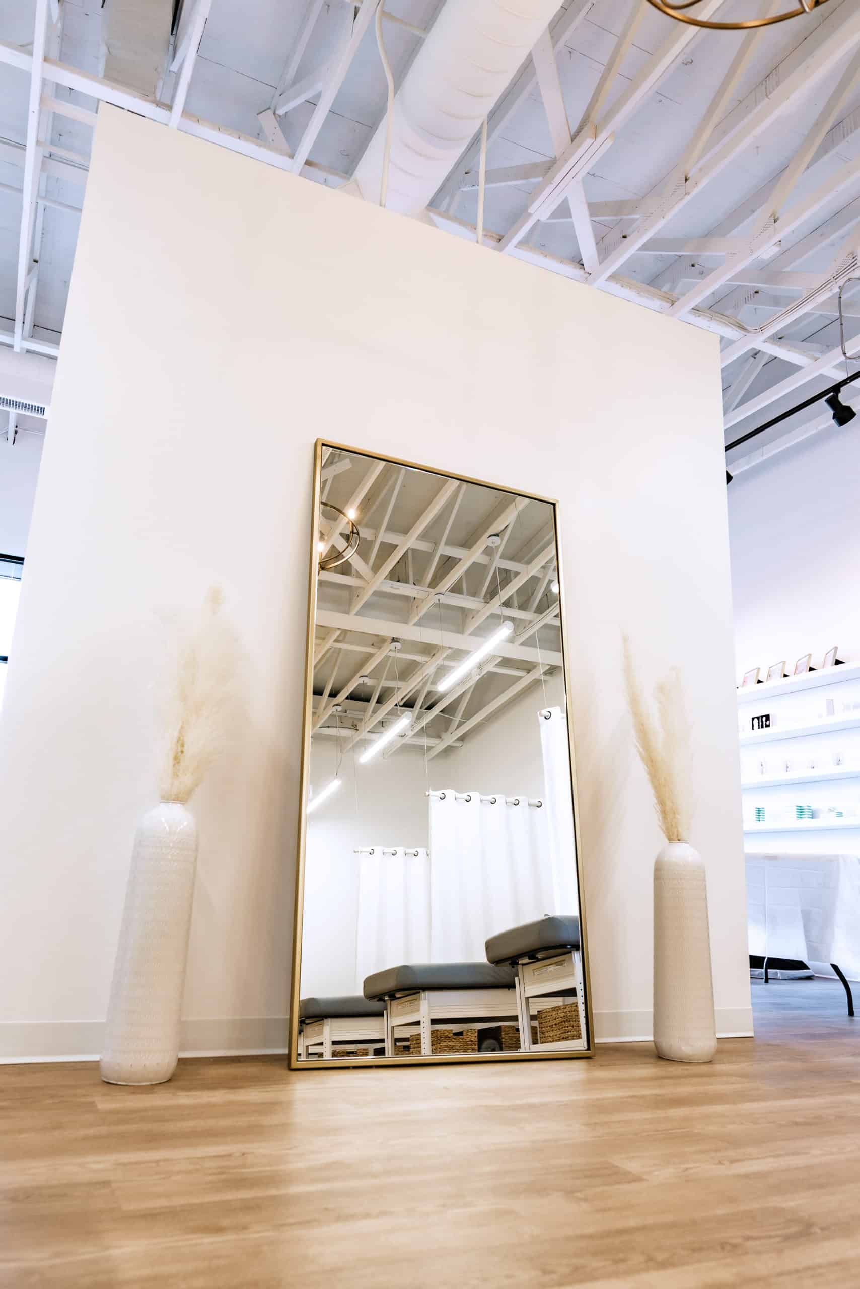 Private treatment room behind tall white arch at FACE FOUNDRIÉ Charleston – Mount Pleasant.