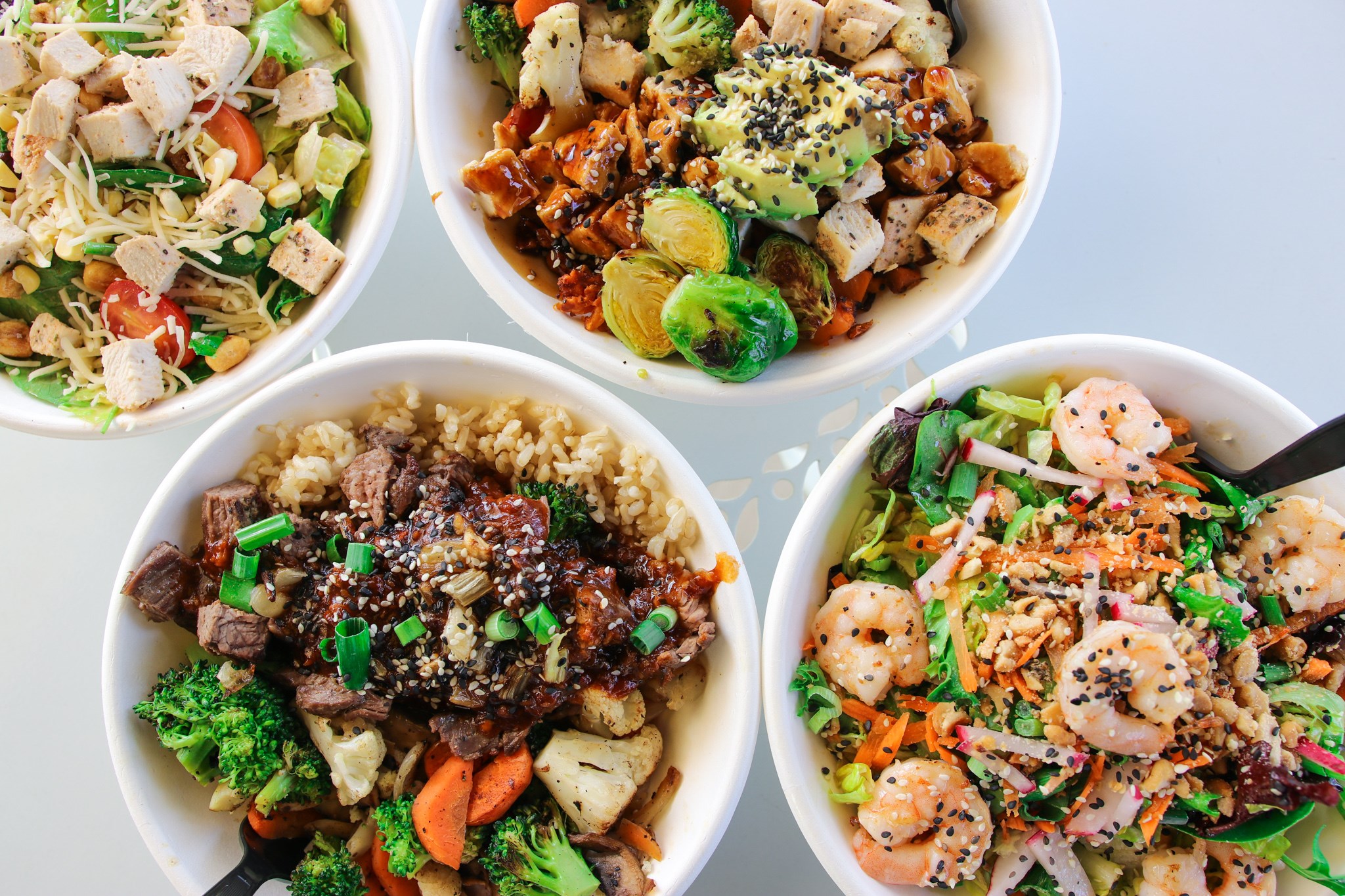 Overhead view of three healthy grain bowls at Original ChopShop Buckhead Atlanta.