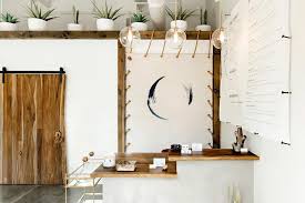 Crescent-moon logo and wood reception counter at The NOW Massage South Lamar Austin.