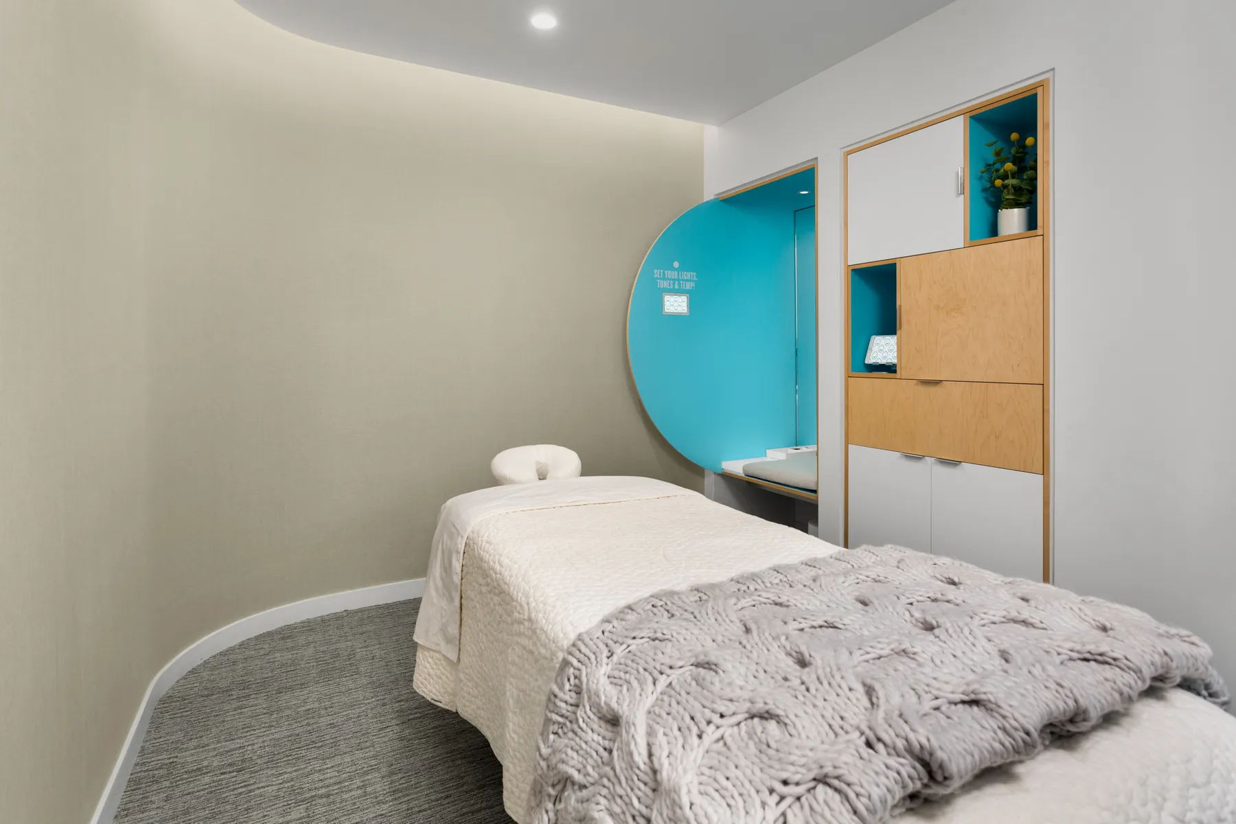 Modern treatment room with cozy linens at Squeeze Charlotte Park Road