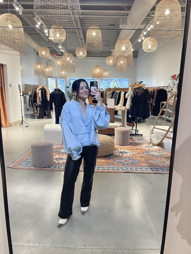 Nina + Leigh Halcyon team member styled in boutique standing inside the store