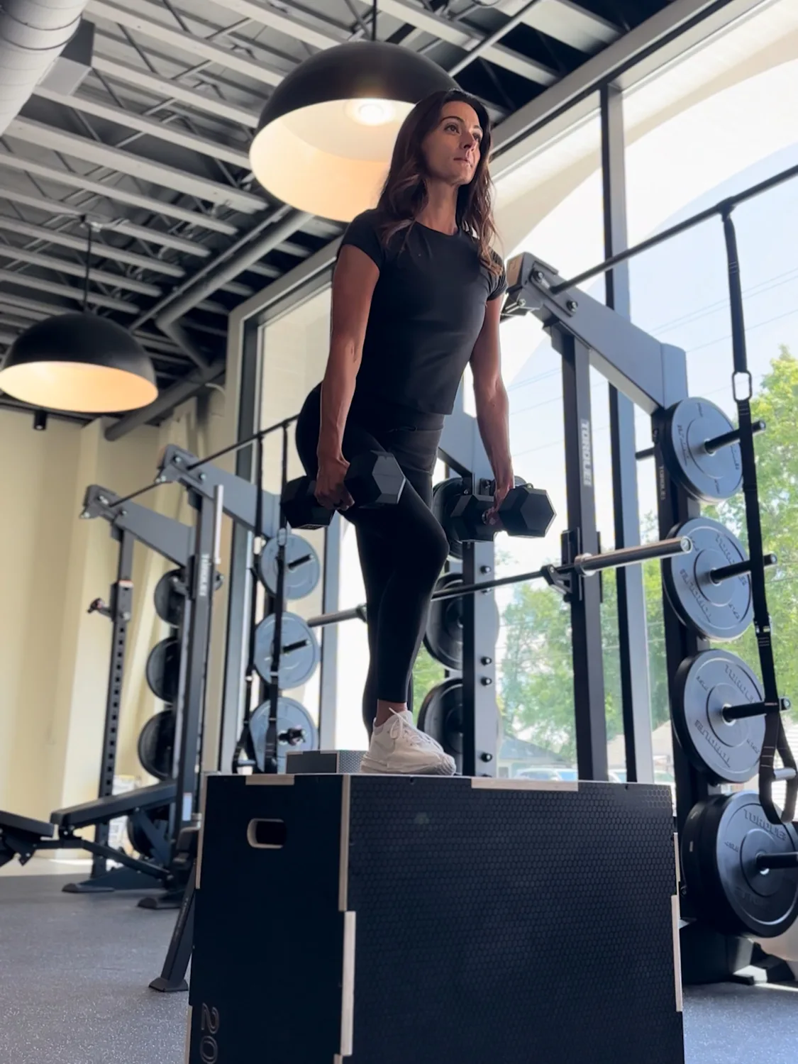 Woman lifting weights in the STAT Wellness Berry Hill training studio