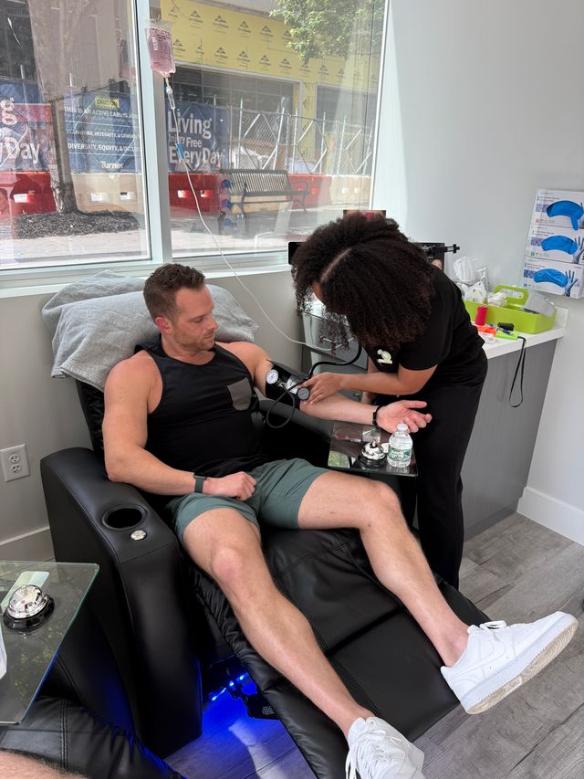 Two clients seated in recliners receiving IV therapy.