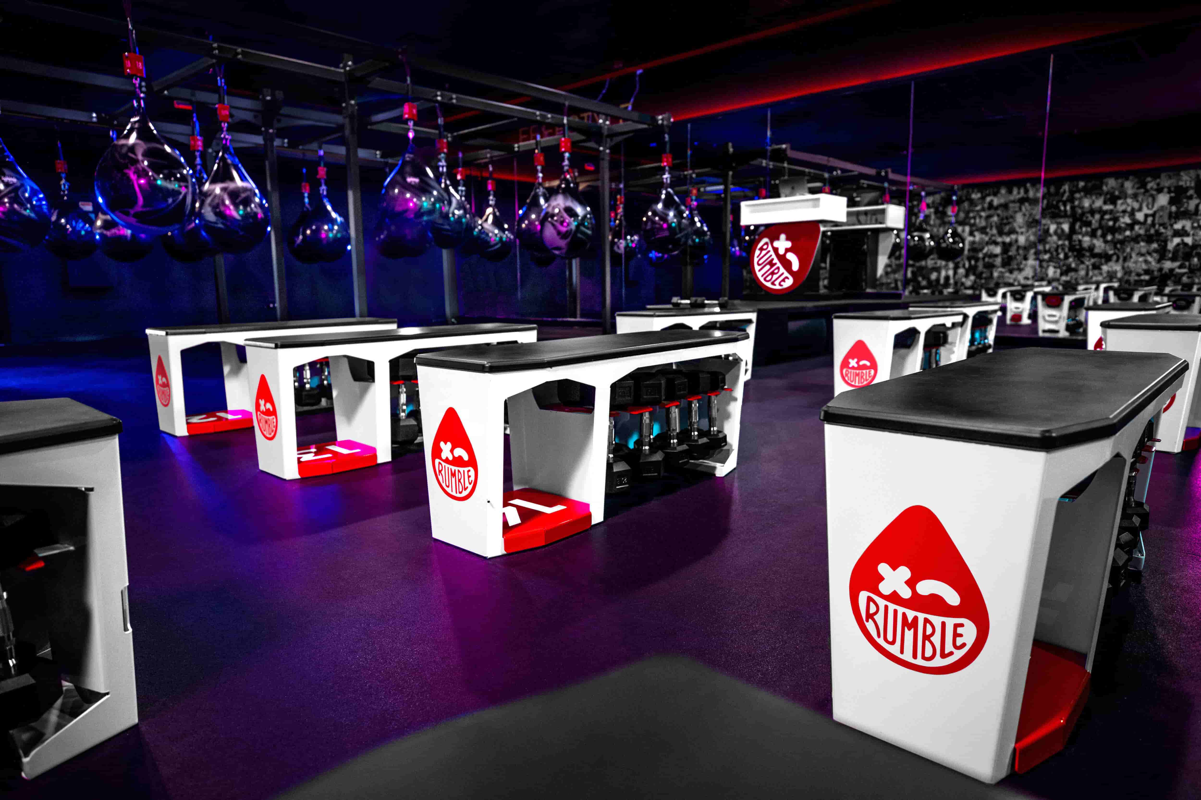 Strength floor with benches and dumbbells at Rumble Boxing Sandy Springs